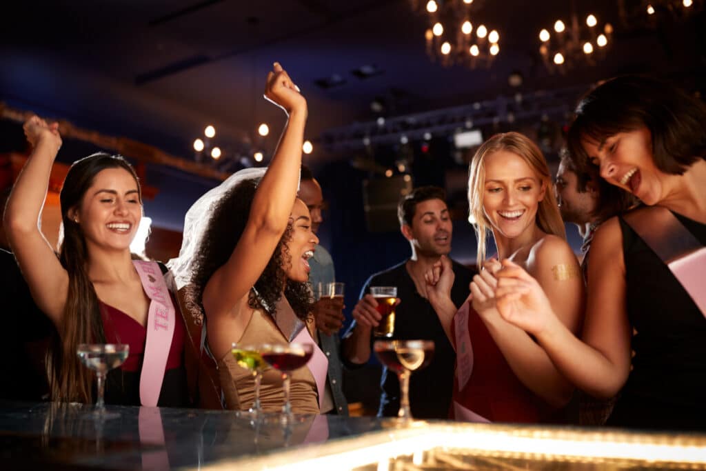 a group of girls celebrating a hen party at a bar